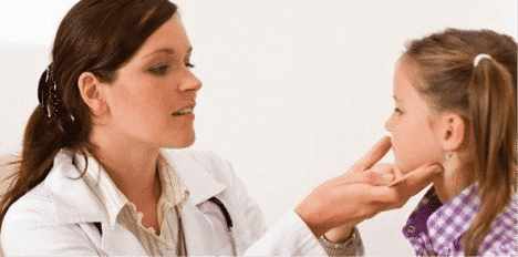 a baby girl and the dentist examining her