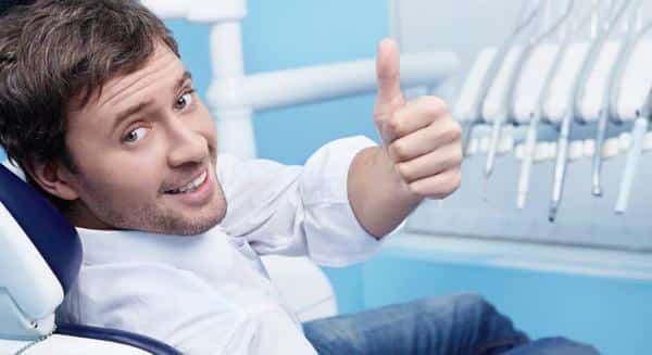 happy man sitting on the dental unit